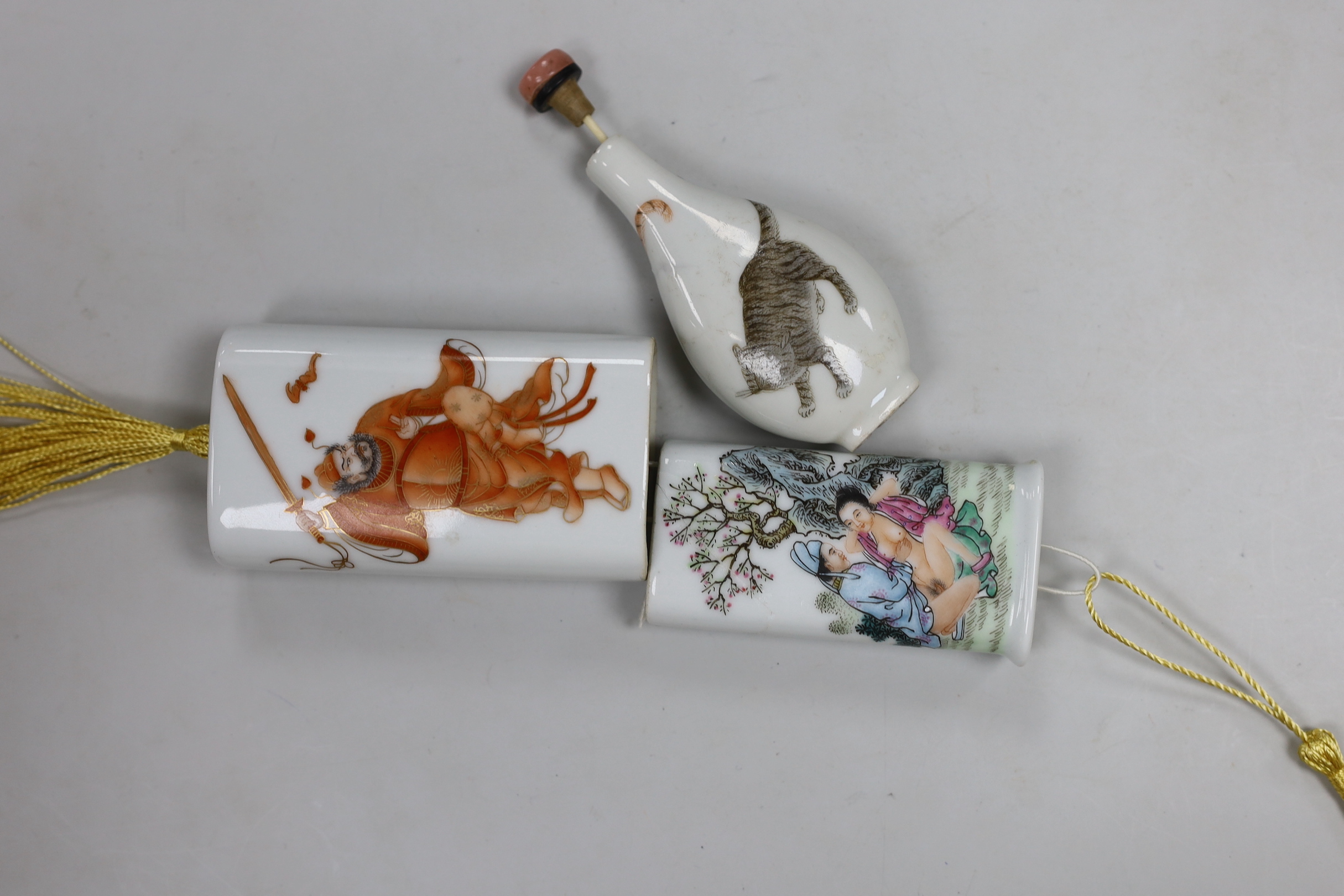 A Chinese famille rose porcelain two part case, painted with figures and an erotic scene, together with a Chinese porcelain snuff bottle enamel painted with a tiger, tallest 9cm high (2)